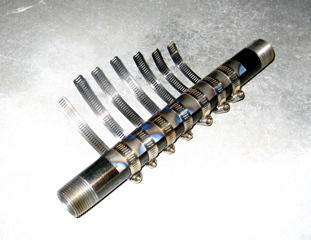 Bending titanium around a pipe using hose clamps.