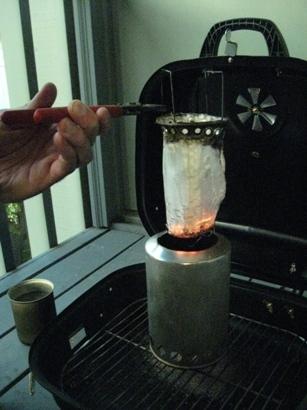 After the test, embers still in the bottom, fabric blackened near the top