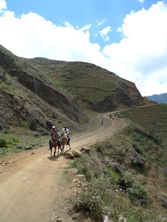Racing past us on horseback.