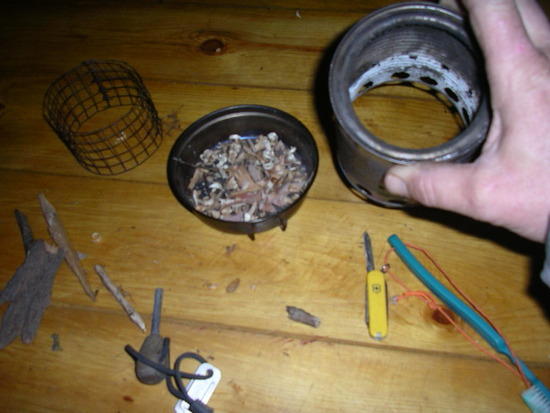 simple soup can with both ends cut out and hole drilled. Some of top lid left for pot stand