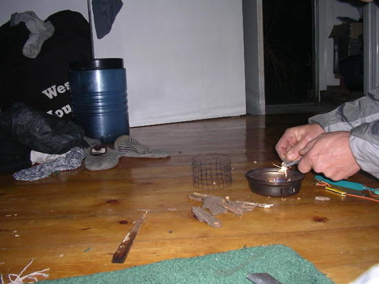 lighting the tinder in the "firebox" lid *actually I took it outside to avoid losing the Apt deposit