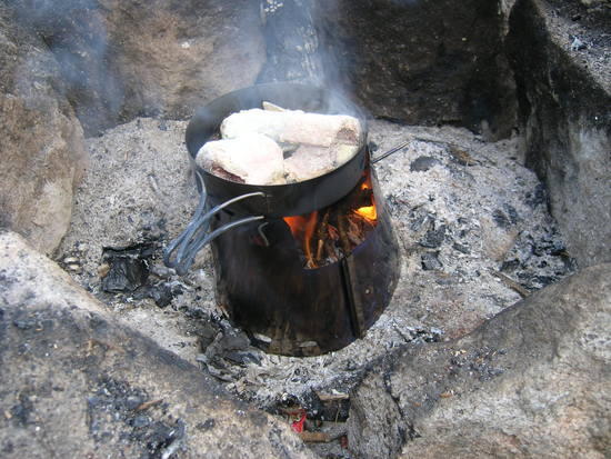 using wood as fuel, frying fish