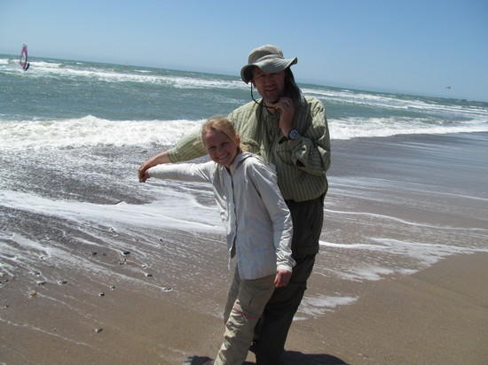 Hannah empties vial with Bay water in Pacific Ocean