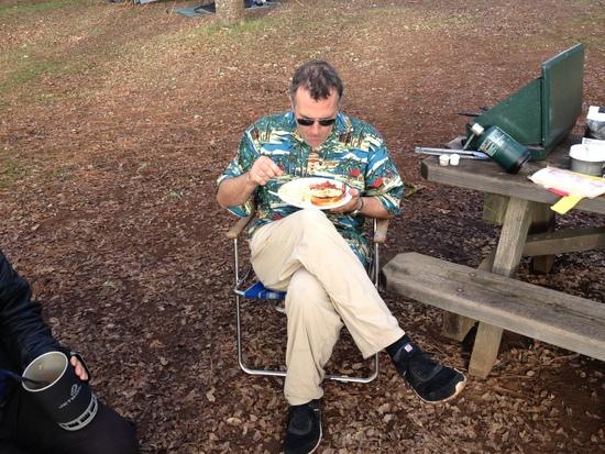 Ken, wearing his official uniform tucks into a hearty breakfast before another day of cat herding.
