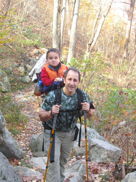 Ciro on Daddy's back climbing Old Rag with his Exped Explorer 130 SA Poles