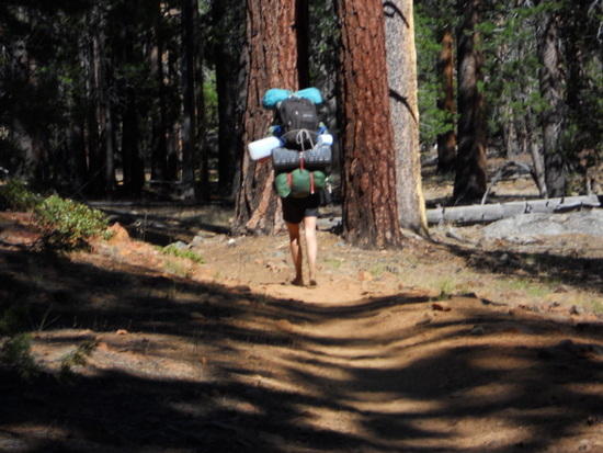 Barefoot hiker with big pack