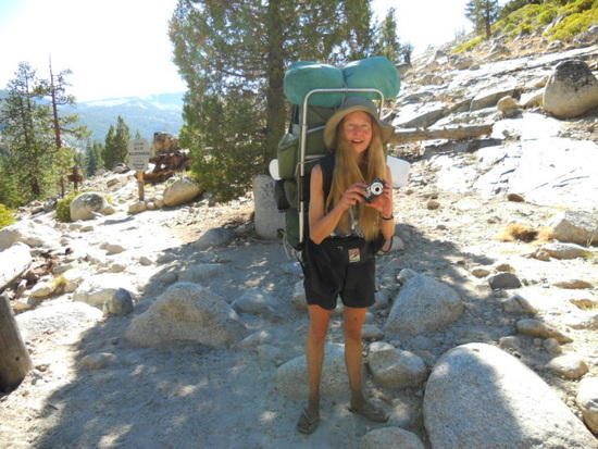 Barefoot hiker with big pack and flip-flops